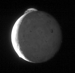 Jupiter's moon Io, showing a volcanic eruption